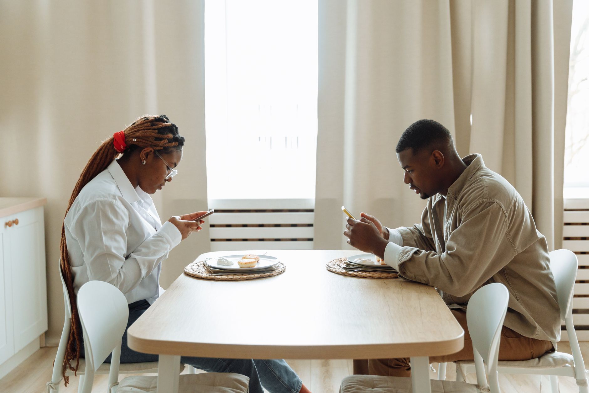 a family at a table setting up smartphone security settings together