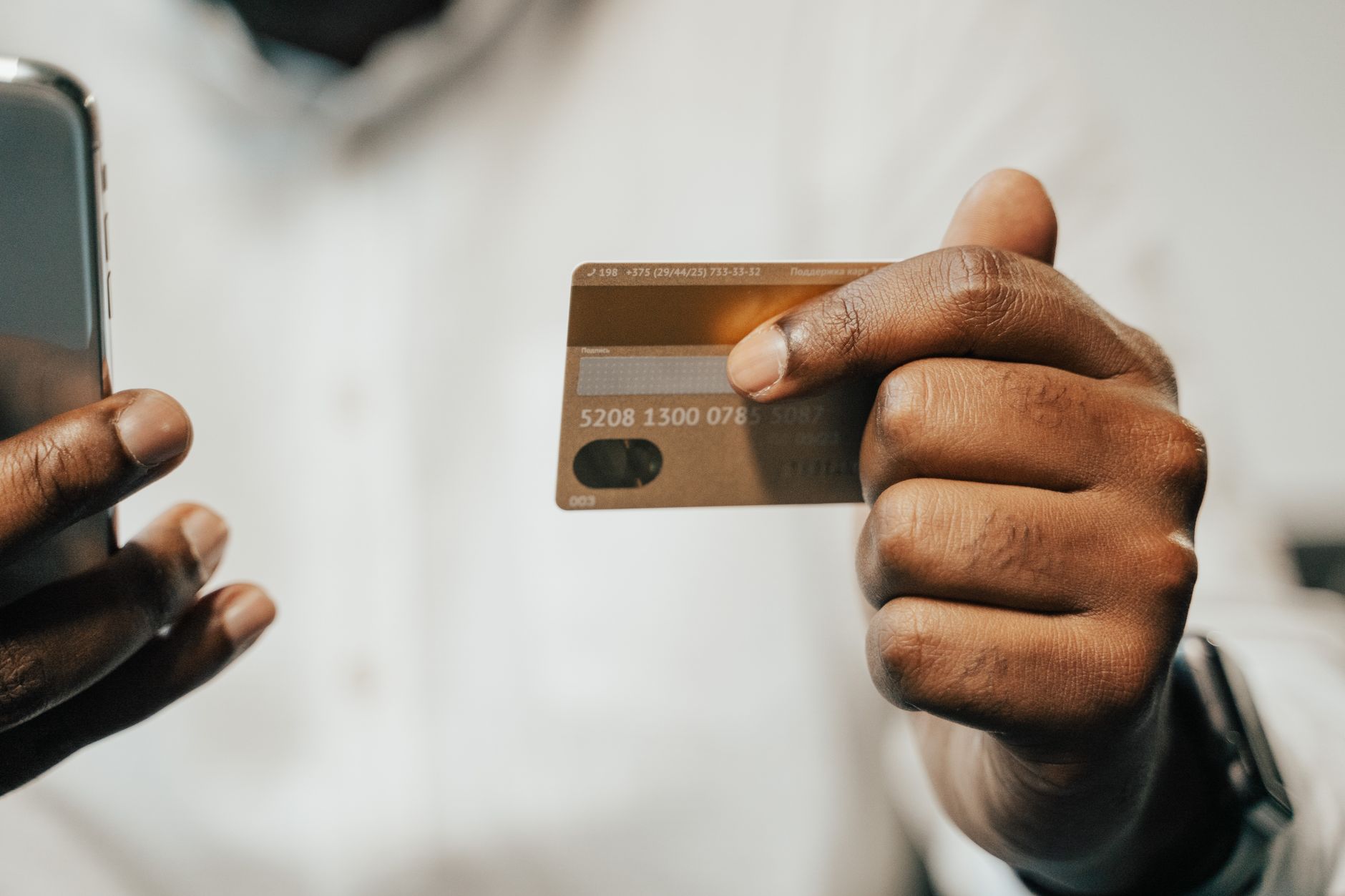 a person holding a credit card and locking it in a mobile banking app