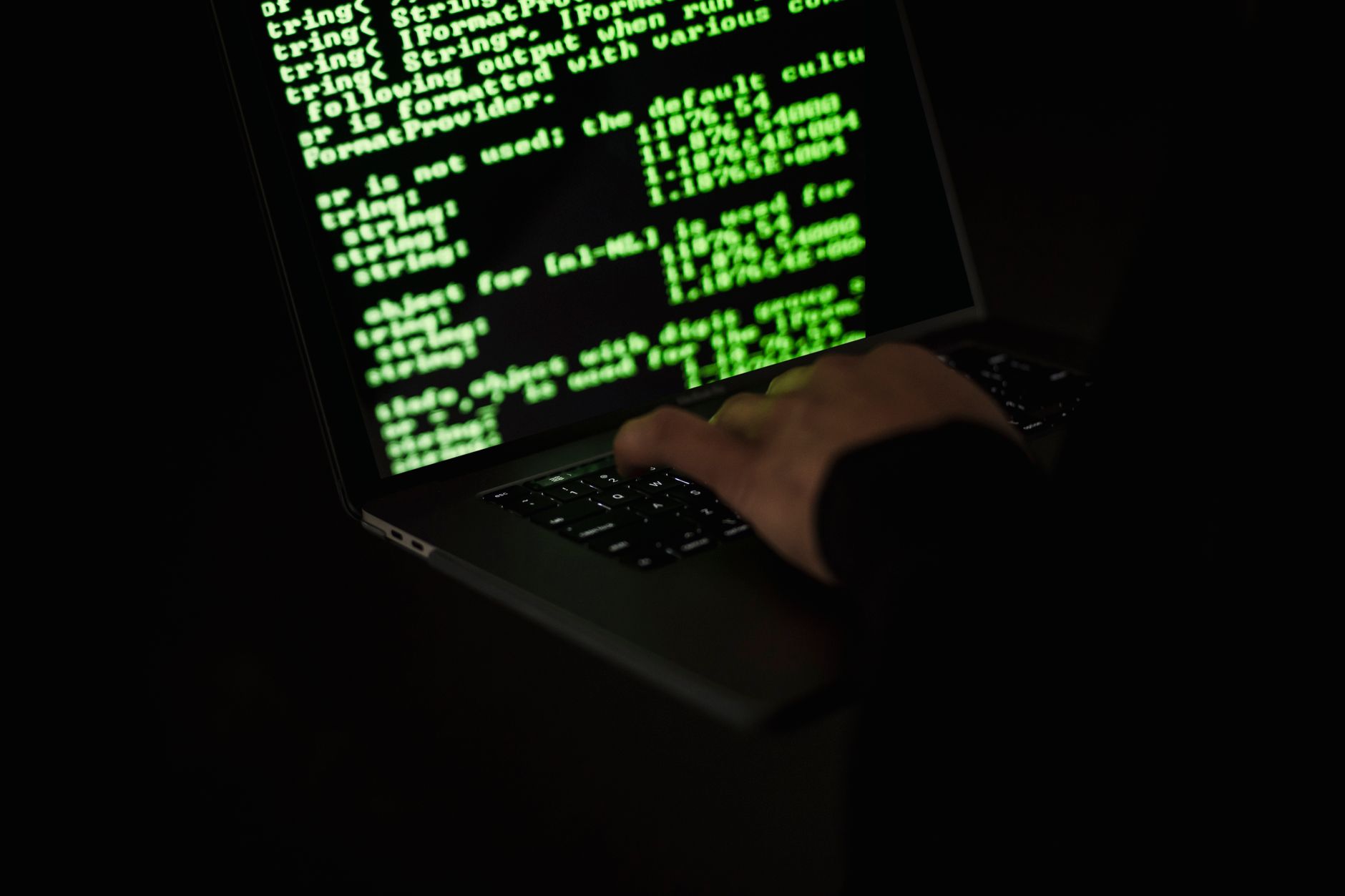 a person reviewing fraud evidence screenshots and documents on a laptop