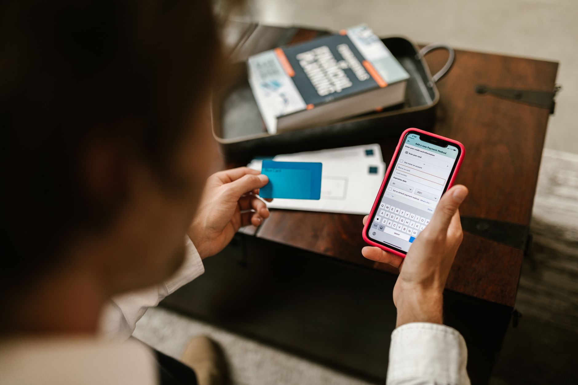 a person holding a bank statement and credit card while calling the bank