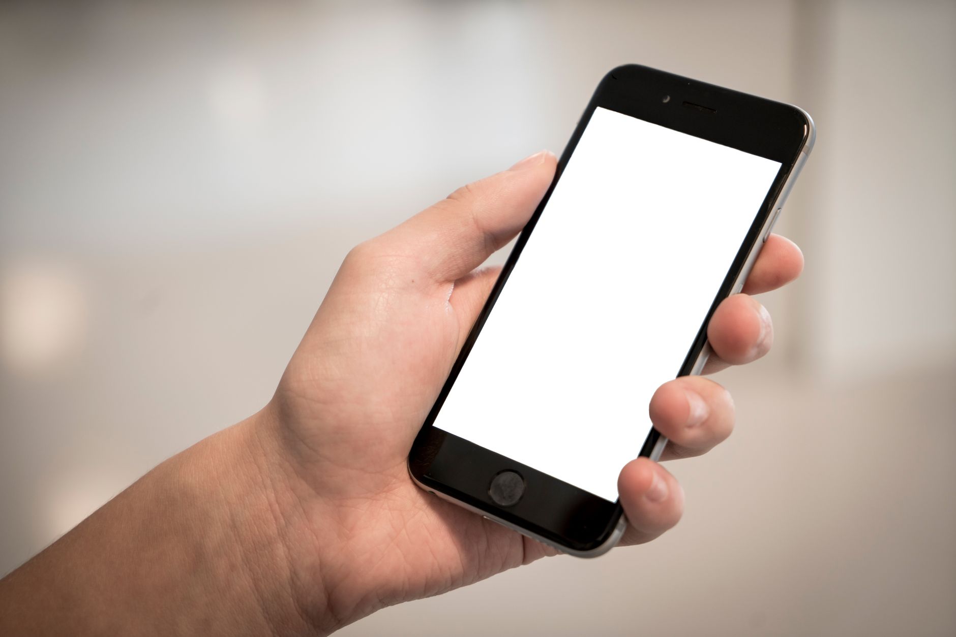 person holding a smartphone with an email recovery screen on the display