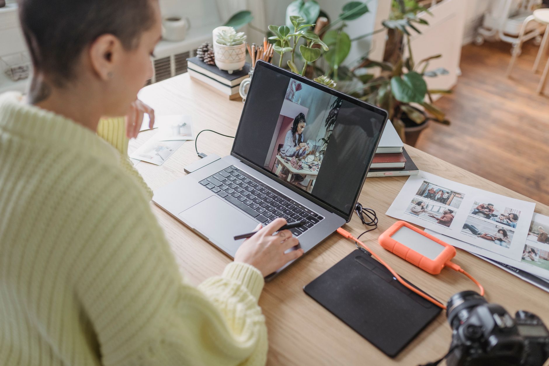 Person editing a portrait photo on a computer screen with software tools, representing AI image manipulation and deepfake creation.